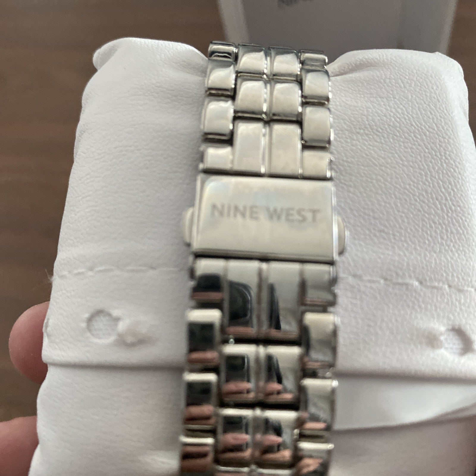 Men’s Nine West wristwatch still in box. Needs new battery.