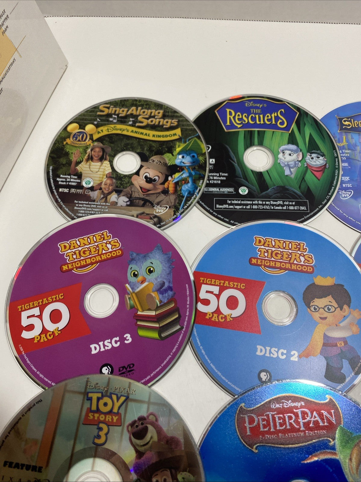 Lot of 20 Disney movie DVDs and sing-along CDs. Please See Photos