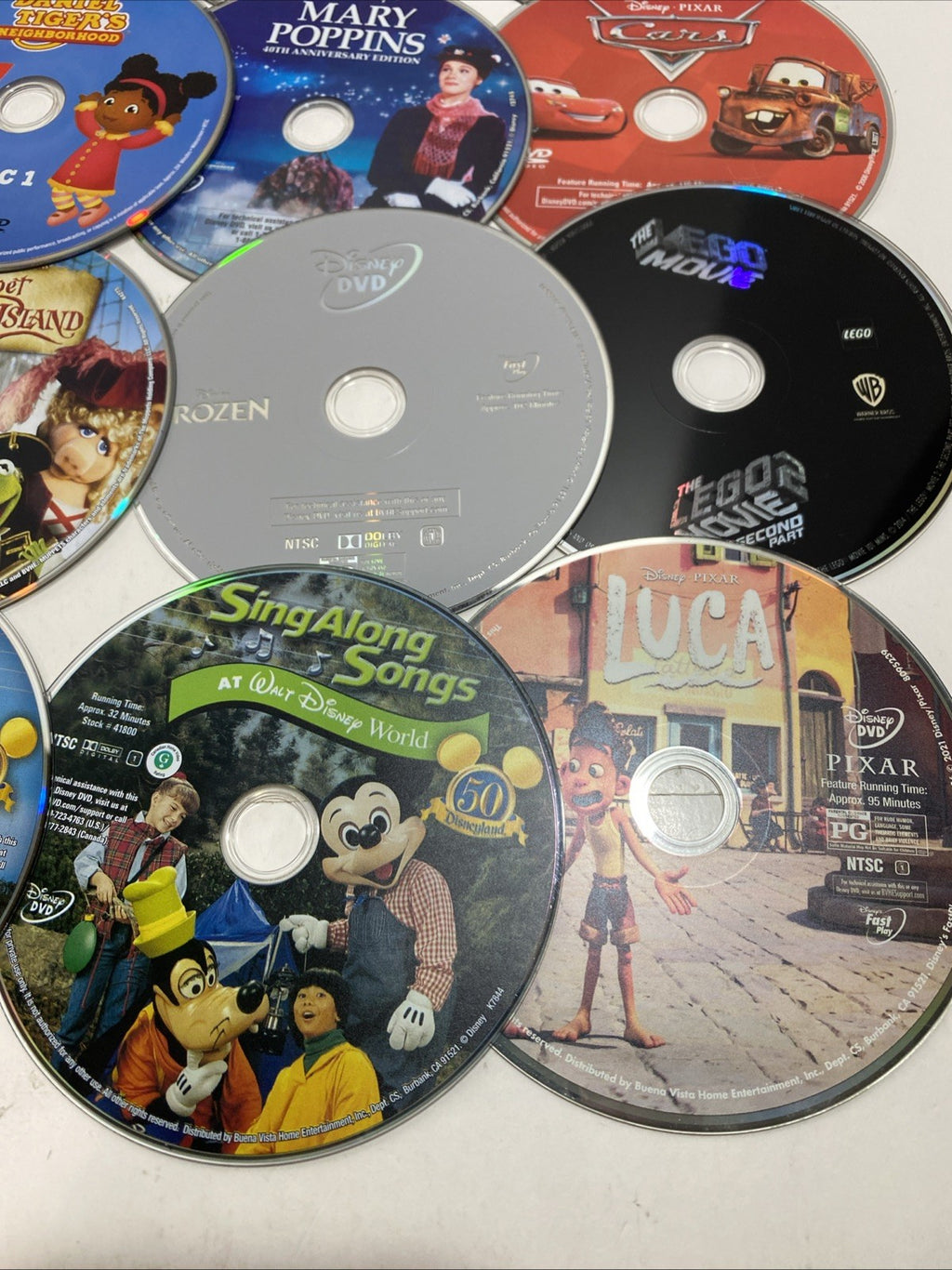 Lot of 20 Disney movie DVDs and sing-along CDs. Please See Photos