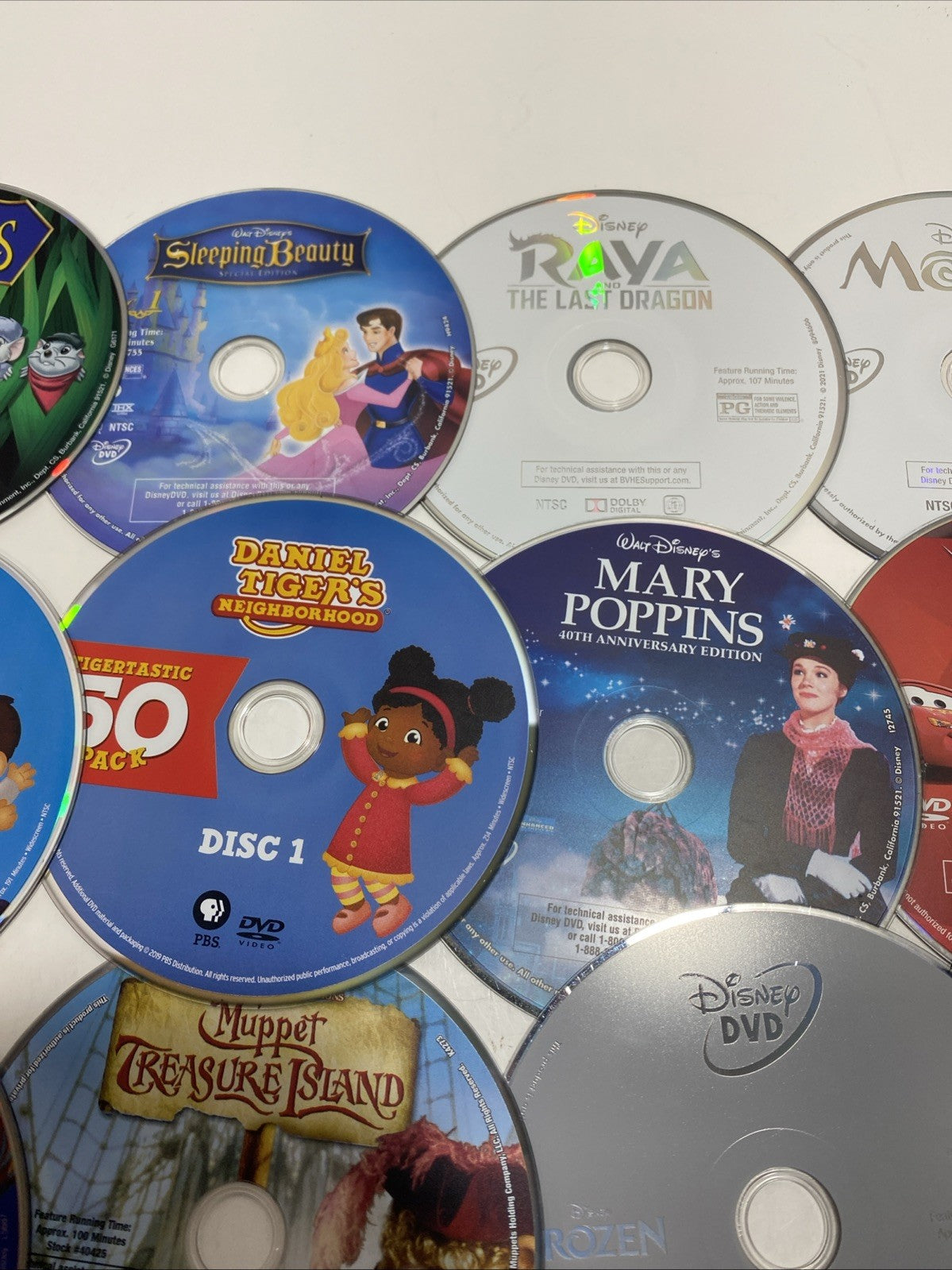 Lot of 20 Disney movie DVDs and sing-along CDs. Please See Photos